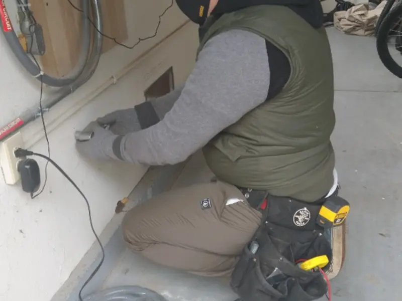 Electrician performing outlet wiring in a Oak Lawn garage